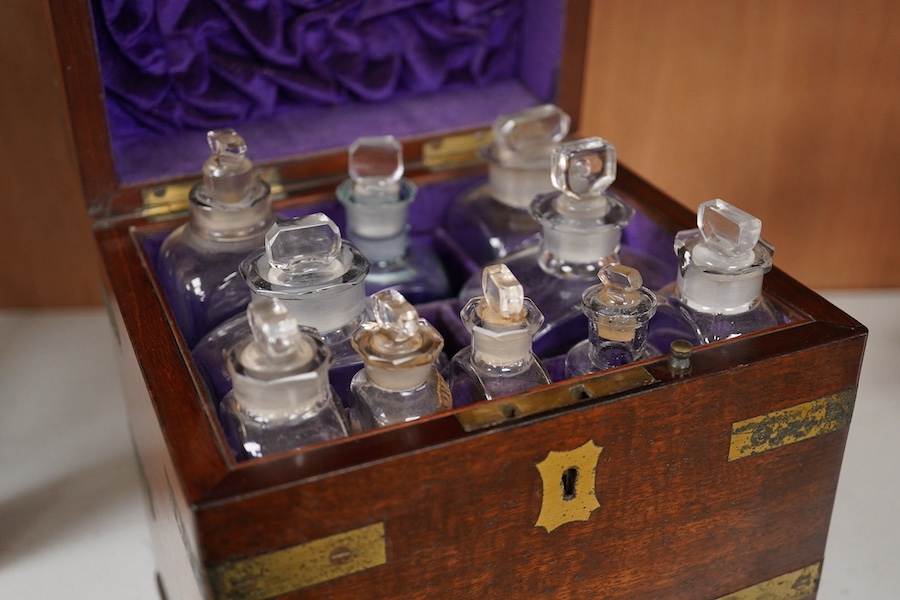 An early 19th century mahogany apothecary box, containing ten glass bottles, one with original paper label for the chemist Elam, 196 Oxford Street, London, with draw beneath containing a pair of scales, and weights, etc.